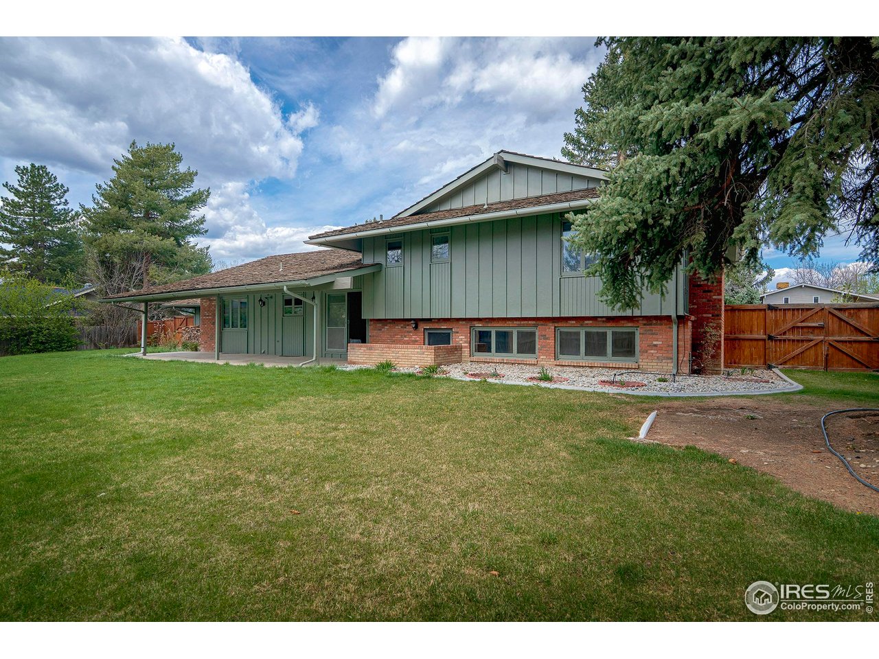 6844 Roaring Fork Trail Boulder, CO 80301 - Photo 31 of 37 a view of a house with a backyard