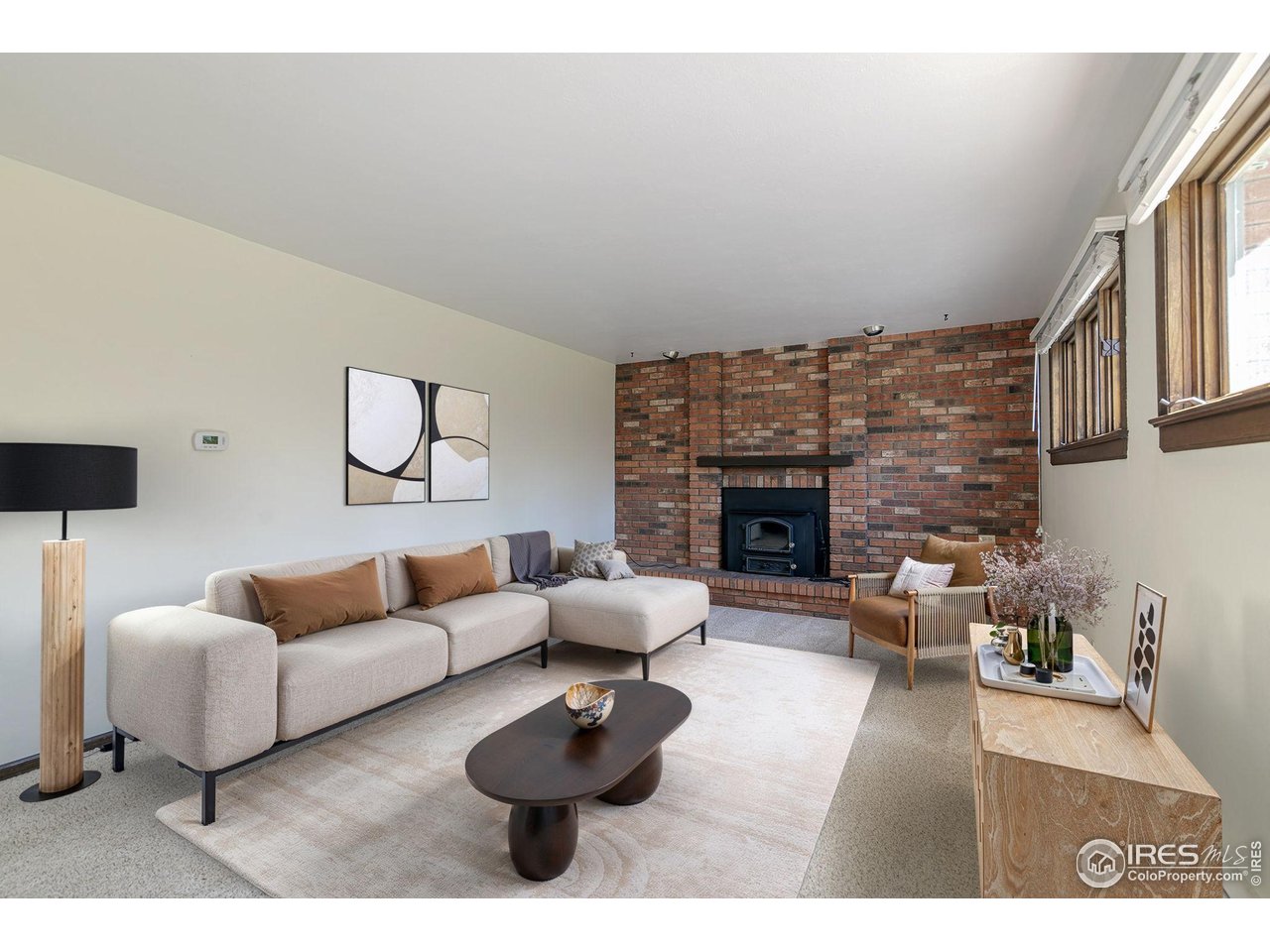 6844 Roaring Fork Trail Boulder, CO 80301 - Photo 4 of 37 a living room with furniture potted plant and a fireplace
