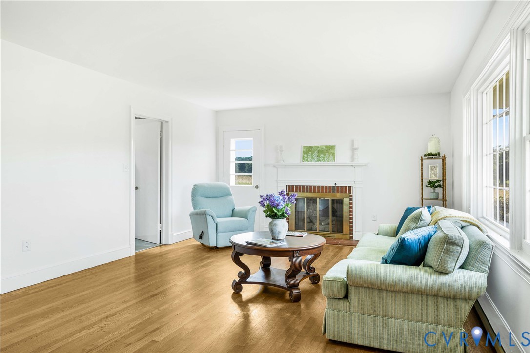 192 Morattico Road Lancaster, VA 22503 - Photo 8 of 34 a living room with furniture a fireplace and a potted plant