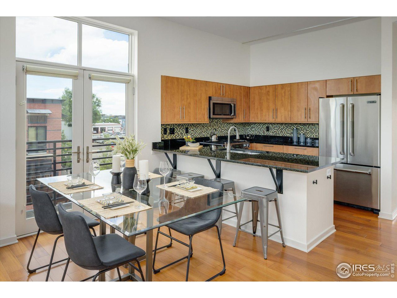 4585 13th Street, Unit D Boulder, CO 80304 - Photo 14 of 30 a kitchen with a table chairs refrigerator and cabinets