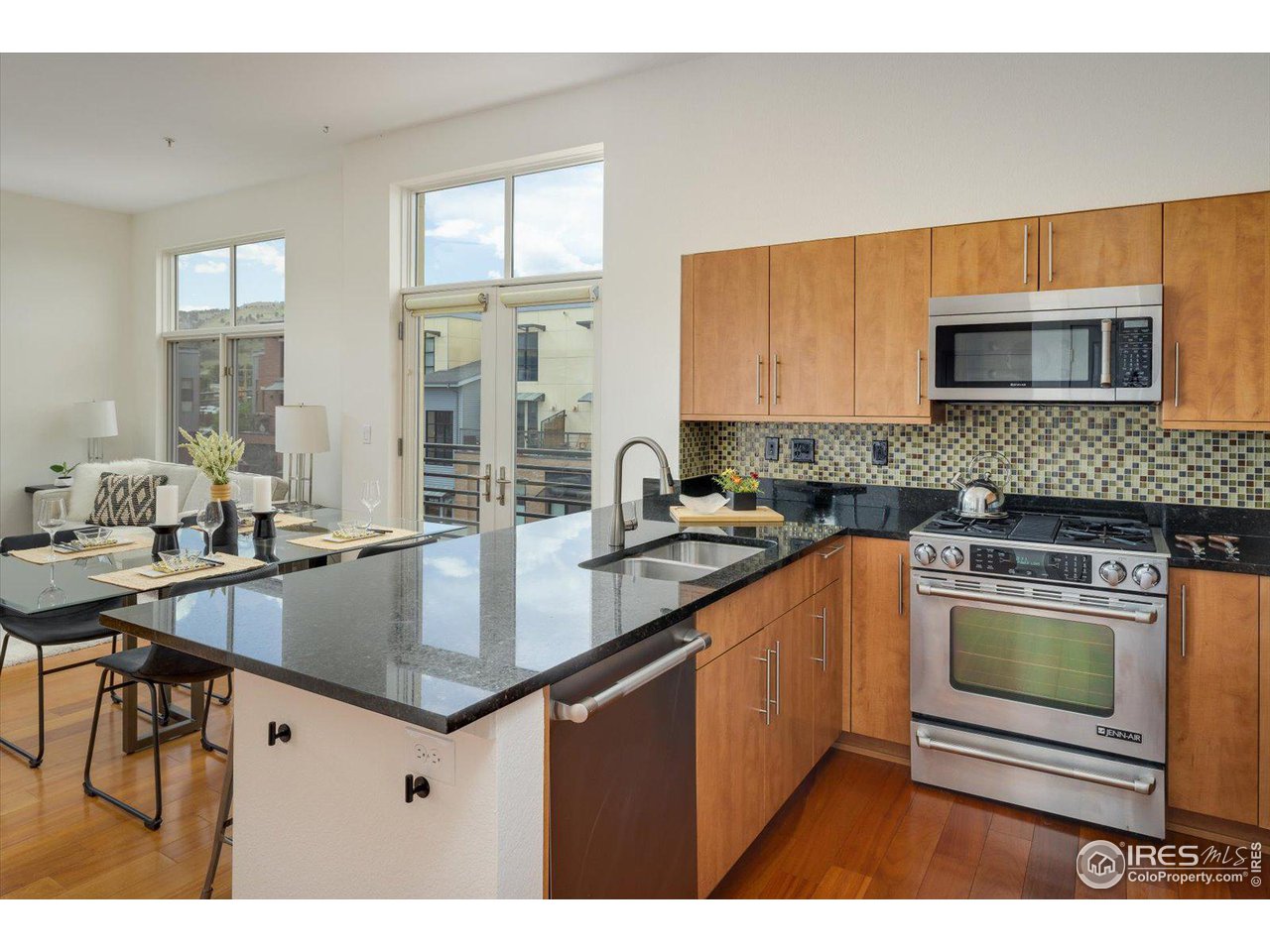 4585 13th Street, Unit D Boulder, CO 80304 - Photo 16 of 30 a kitchen with stainless steel appliances granite countertop a sink stove and microwave