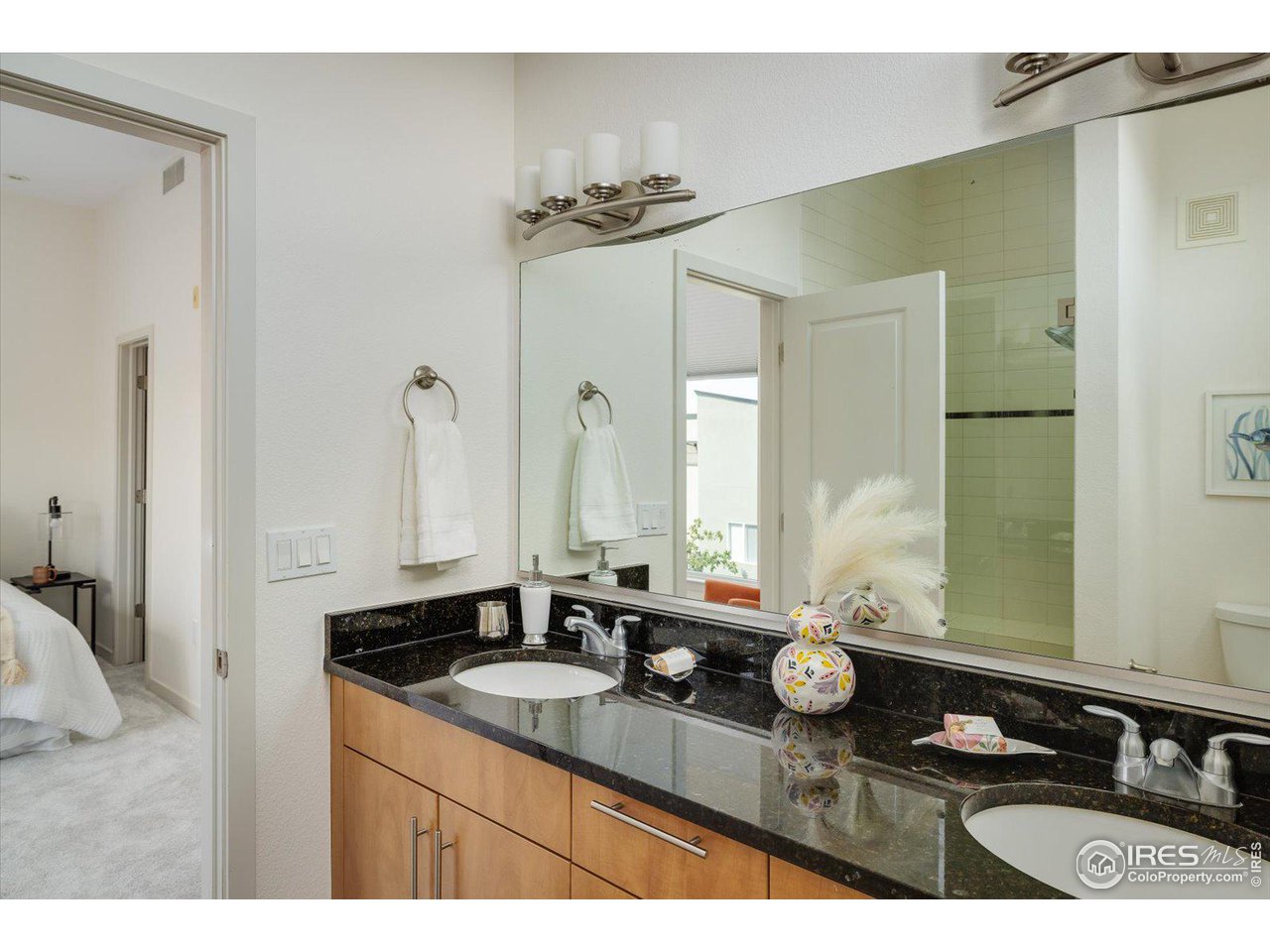 4585 13th Street, Unit D Boulder, CO 80304 - Photo 21 of 30 a bathroom with a granite countertop sink and a mirror