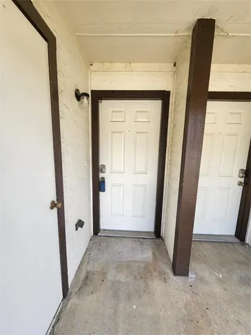a view of a livingroom with wooden floor and a ceiling fan