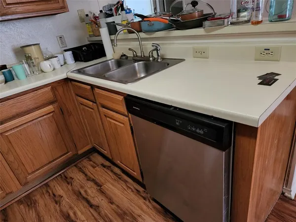 a kitchen with stainless steel appliances a refrigerator sink and cabinets