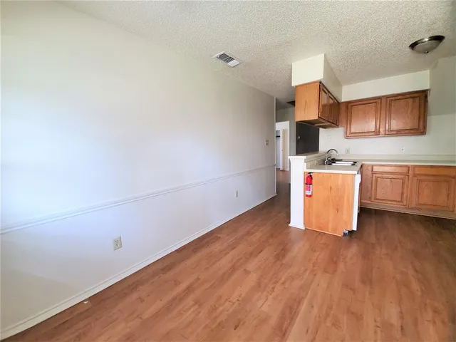 a room with a wooden floor and a sink