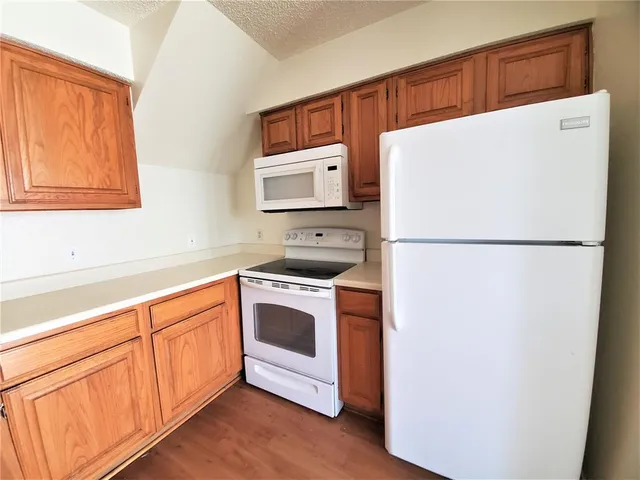 a kitchen with stainless steel appliances a refrigerator sink and microwave