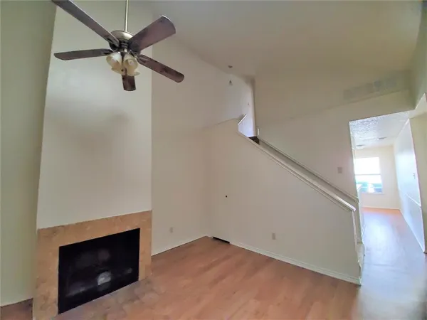 a view of a livingroom with a ceiling fan and a fireplace
