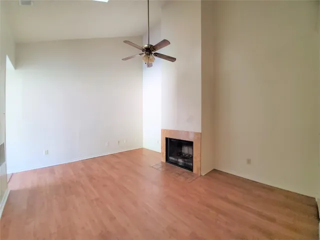 a view of empty room with a fireplace