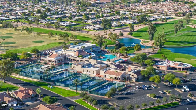 an aerial view of residential houses with outdoor space and swimming pool