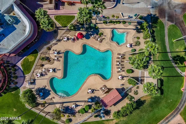 an aerial view of a swimming pool patio outdoor seating and outdoor kitchen