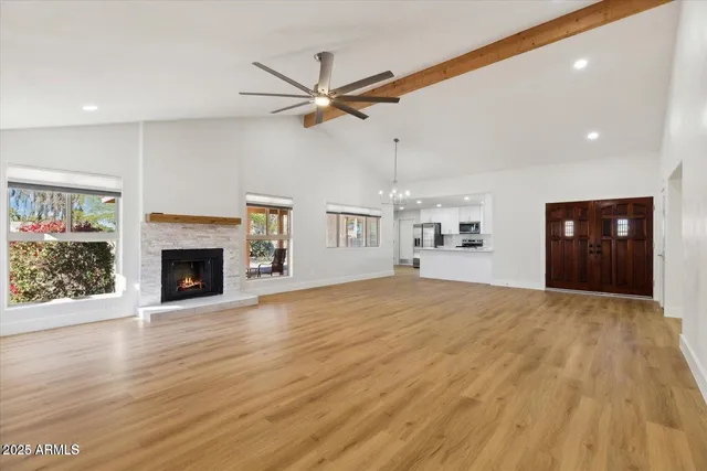 a view of an empty room with a fireplace and a window