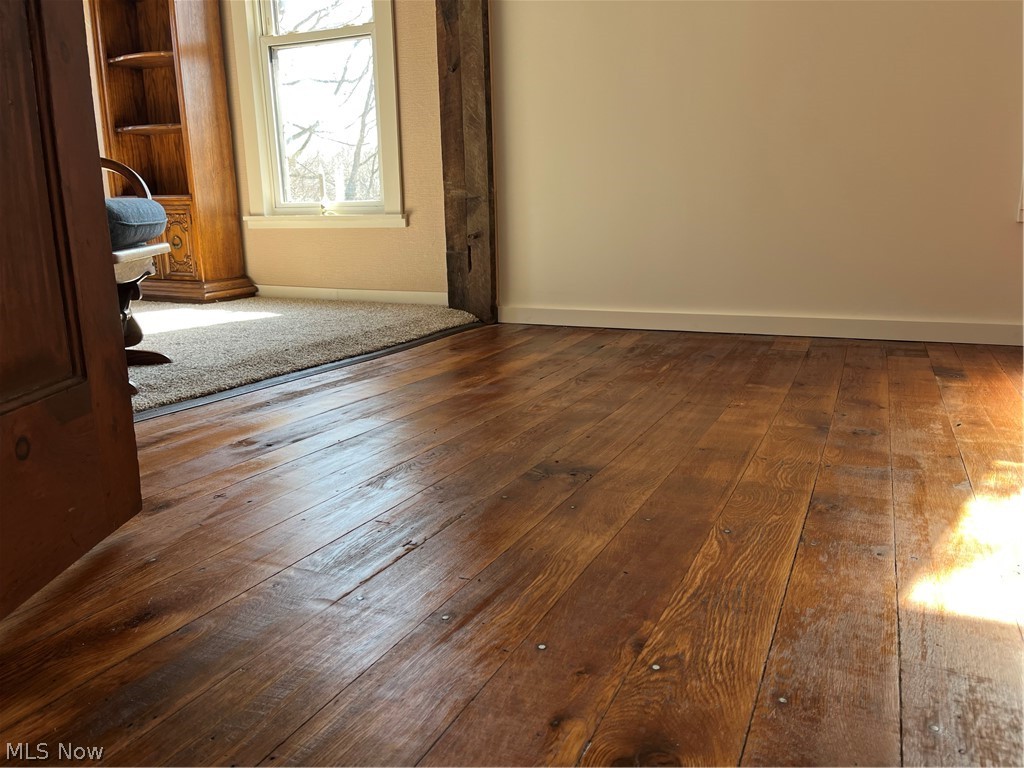 12972 Gilmore Road Southeast Port Washington, OH 43837 - Photo 28 of 50 Unfurnished room featuring baseboards and dark wood finished floors