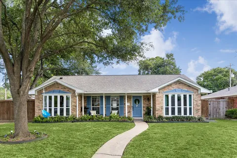 a front view of a house with a garden and porch