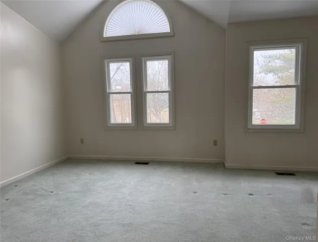 a spacious bedroom with a bed and a couch