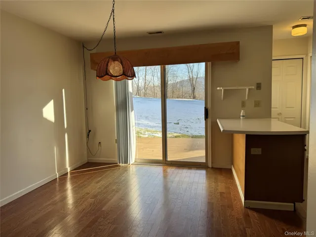 a view of a kitchen with a sink and wooden floor