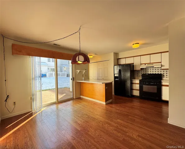 a view of a room with wooden floor