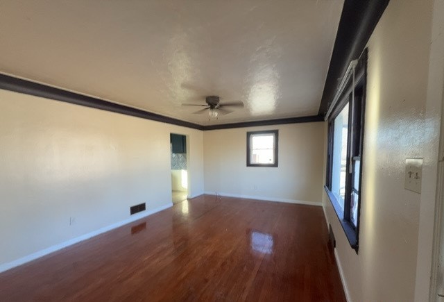 2111 Alexander Street Granite City, IL 62040 - Photo 2 of 12 an empty room with wooden floor and windows
