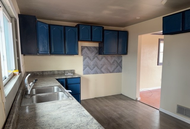 2111 Alexander Street Granite City, IL 62040 - Photo 4 of 12 a kitchen with granite countertop a sink a stove and a refrigerator