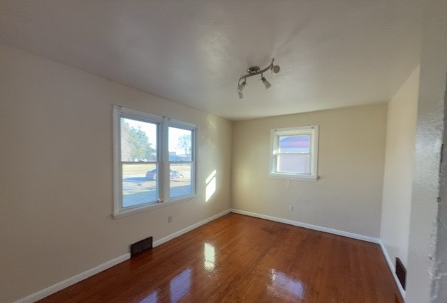 2111 Alexander Street Granite City, IL 62040 - Photo 6 of 12 wooden floor in an empty room with a window