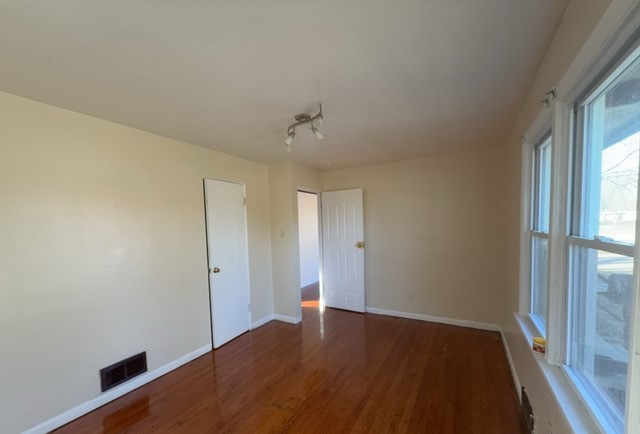 2111 Alexander Street Granite City, IL 62040 - Photo 7 of 12 an empty room with wooden floor and windows