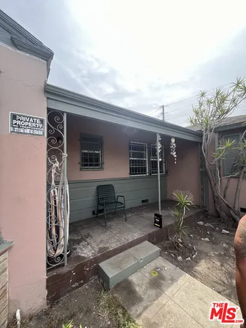 a backyard of a house with barbeque oven table and chairs