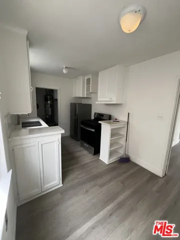a room with wooden floor and electronic appliances