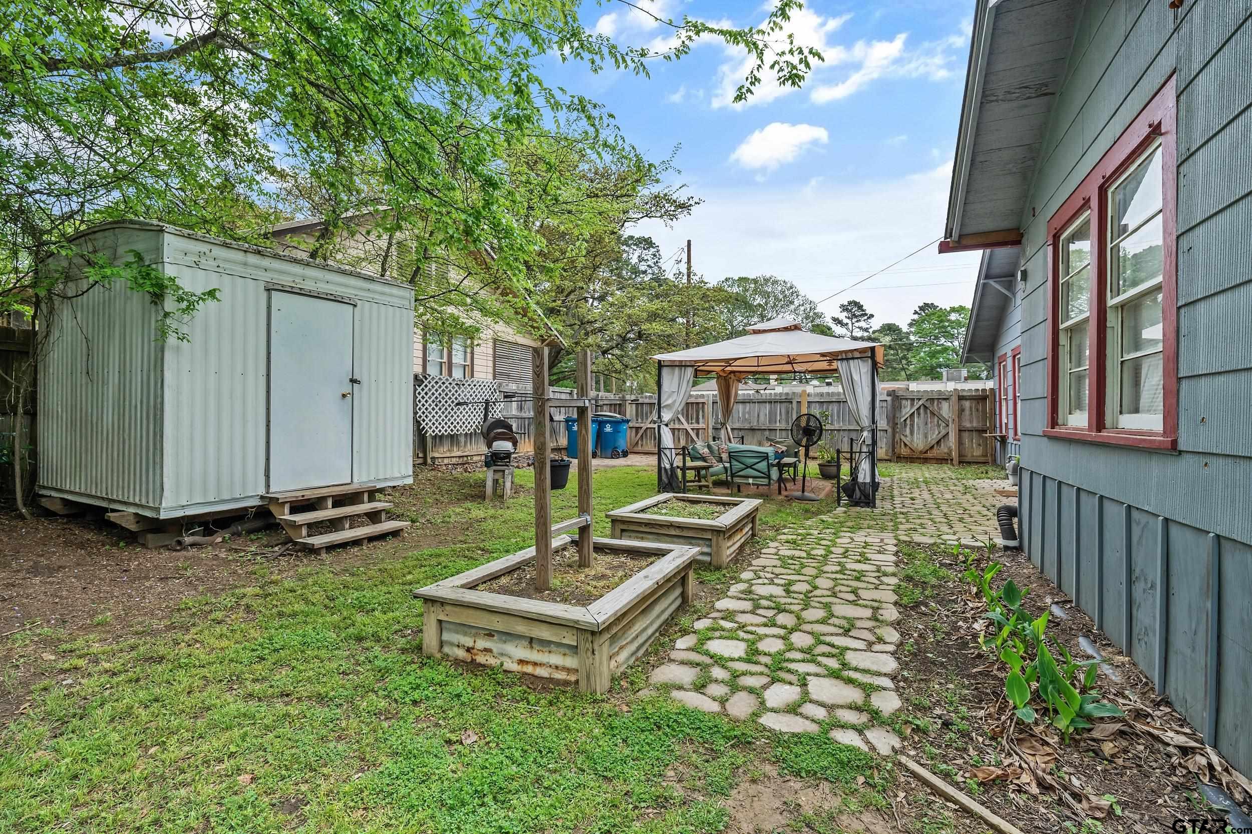 402 Bonner Street Rusk, TX 75785 - Photo 7 of 25 a view of a house with backyard sitting area and garden