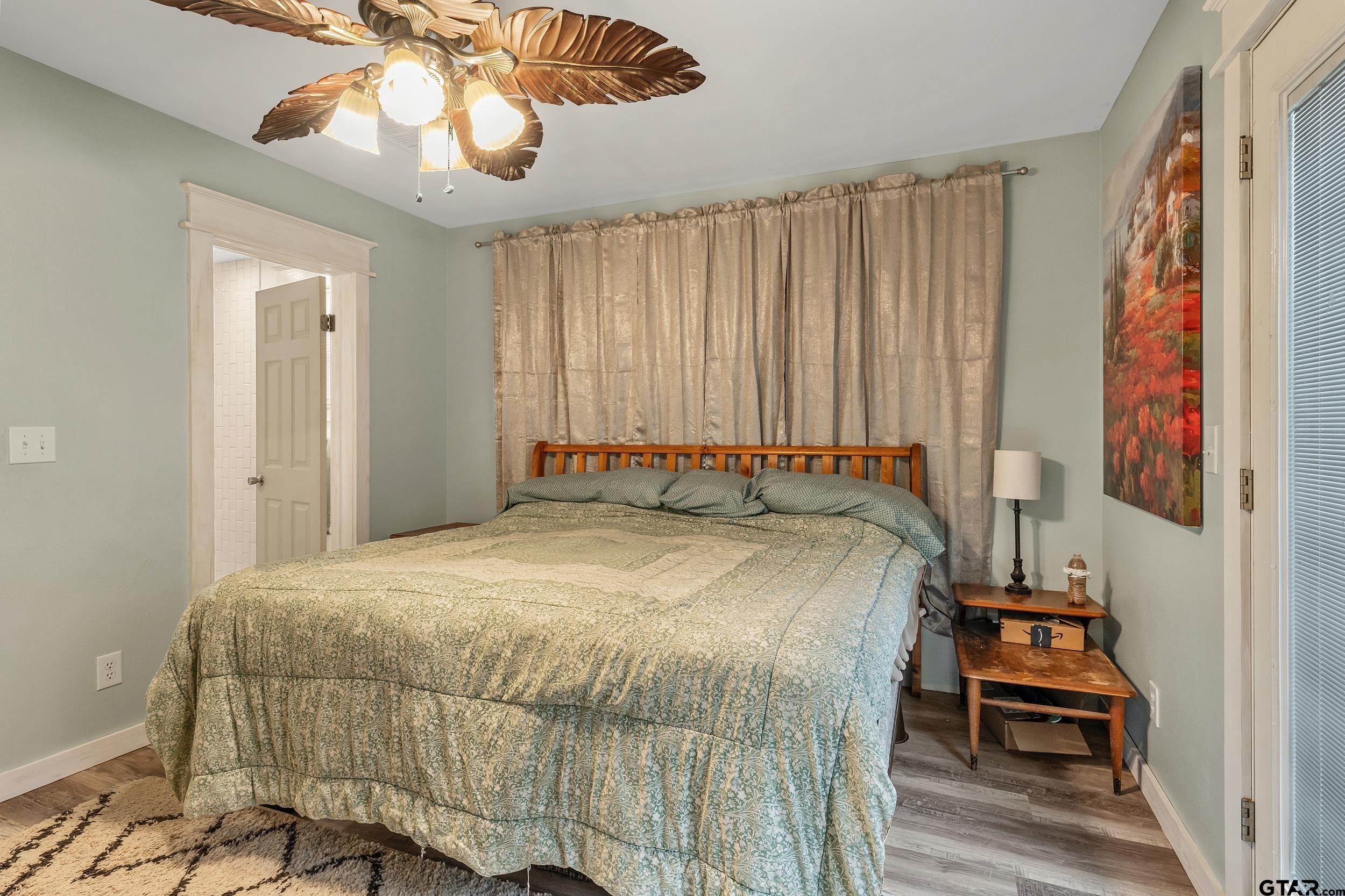 402 Bonner Street Rusk, TX 75785 - Photo 9 of 25 a bedroom with a bed and a chandelier