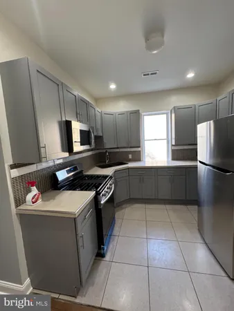 a kitchen with a refrigerator a stove a microwave and cabinets