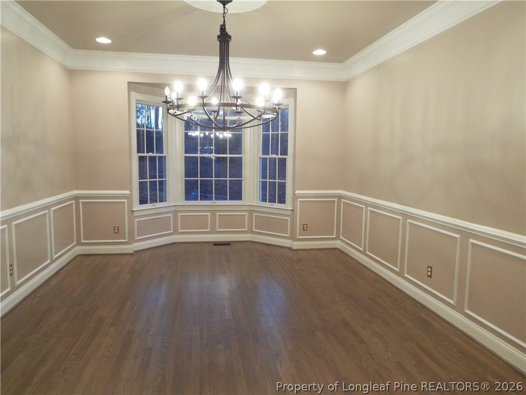 203 Ticonderoga Road Cary, NC 27519 - Photo 11 of 18 a view of an empty room with wooden floor and a window