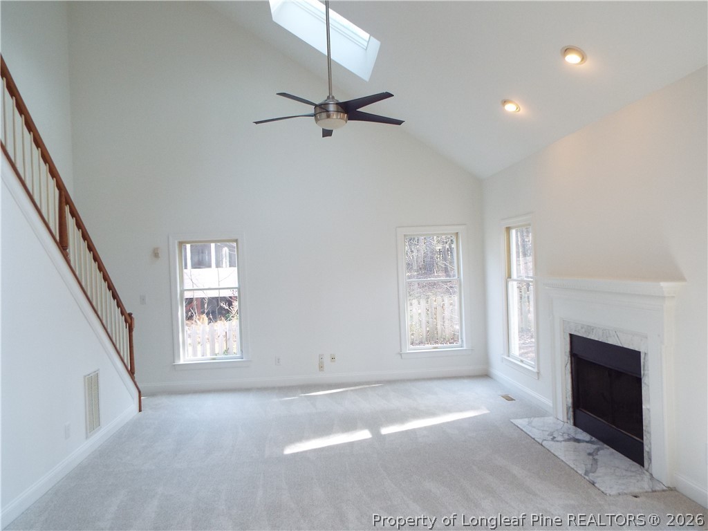 203 Ticonderoga Road Cary, NC 27519 - Photo 12 of 18 an empty room with windows and fireplace