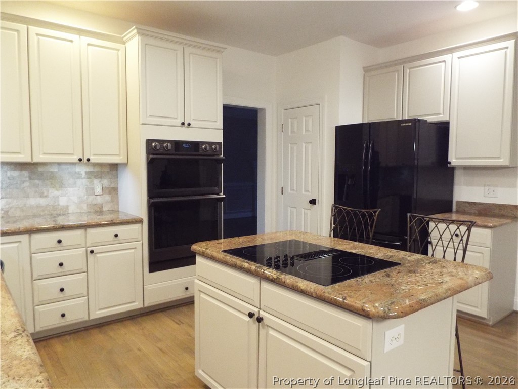203 Ticonderoga Road Cary, NC 27519 - Photo 13 of 18 a kitchen with granite countertop a refrigerator and a sink