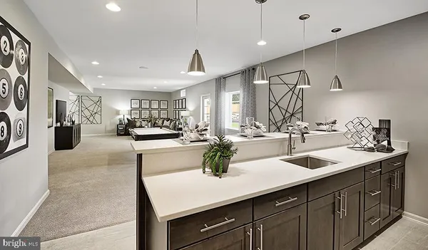 a kitchen with sink refrigerator and cabinets