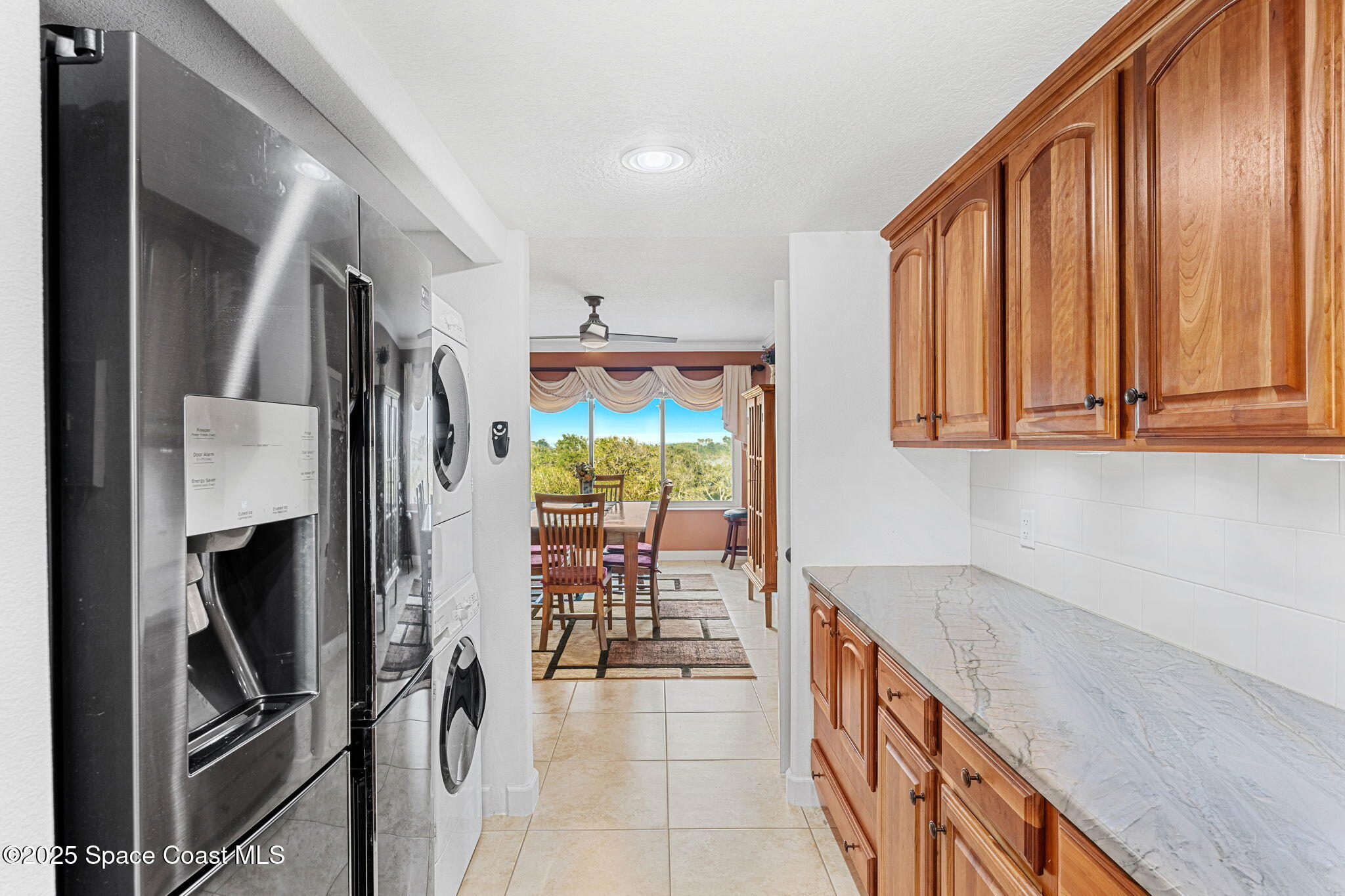 2220 Front Street, Unit 404 Melbourne, FL 32901 - Photo 11 of 52 a kitchen with stainless steel appliances granite countertop a refrigerator and a sink