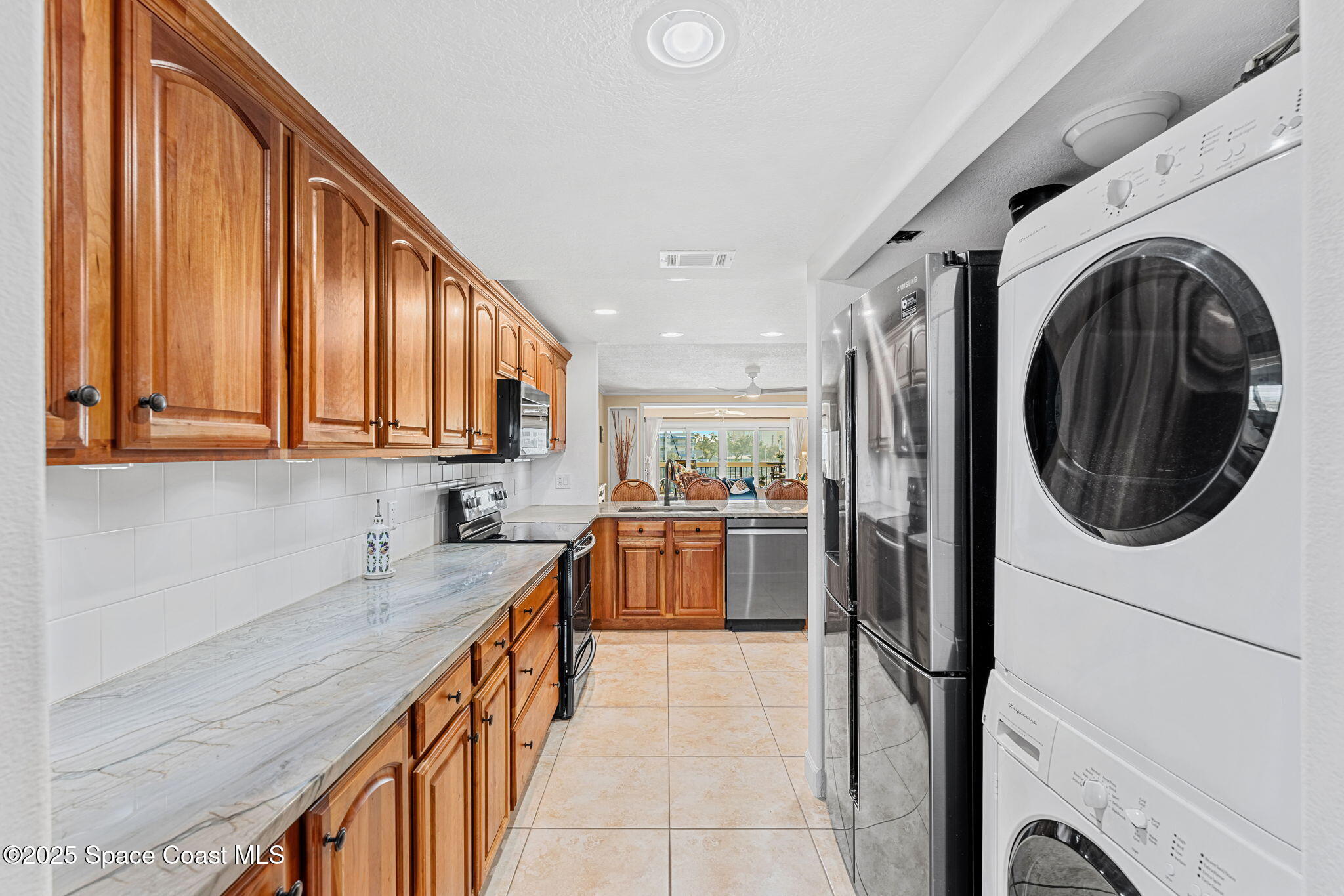 2220 Front Street, Unit 404 Melbourne, FL 32901 - Photo 15 of 52 a kitchen with a refrigerator and a sink