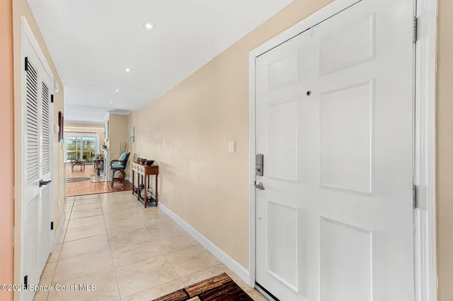 a living room with furniture a couch and a floor to ceiling window