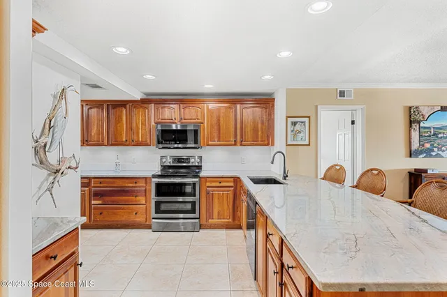 a kitchen with stainless steel appliances granite countertop a sink and cabinets