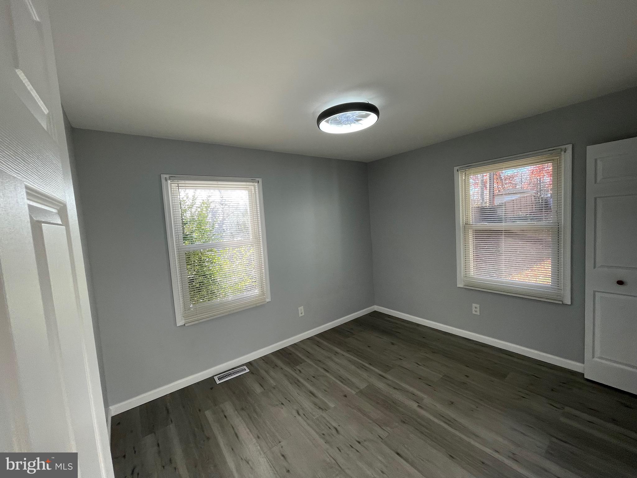 229 Garner Avenue Waldorf, MD 20602 - Photo 14 of 25 an empty room with wooden floor and windows