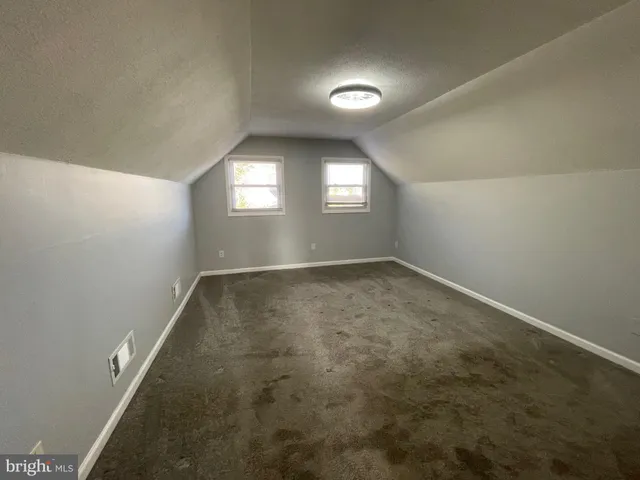 an empty room with a empty space and windows