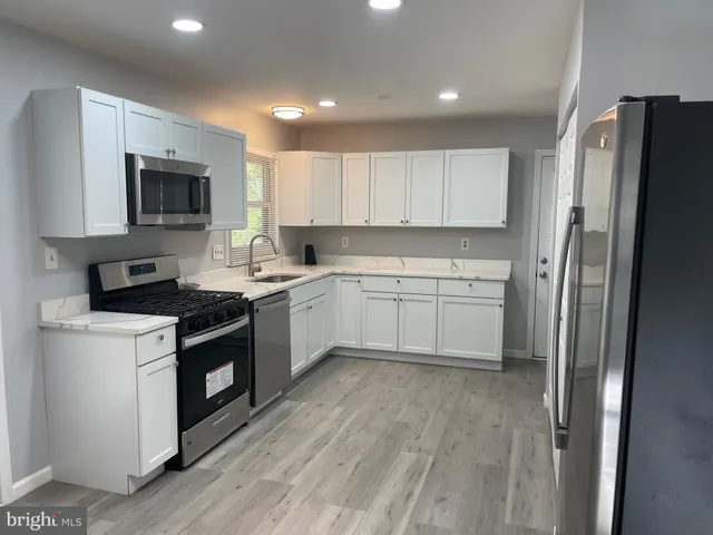a kitchen with a sink stove and refrigerator