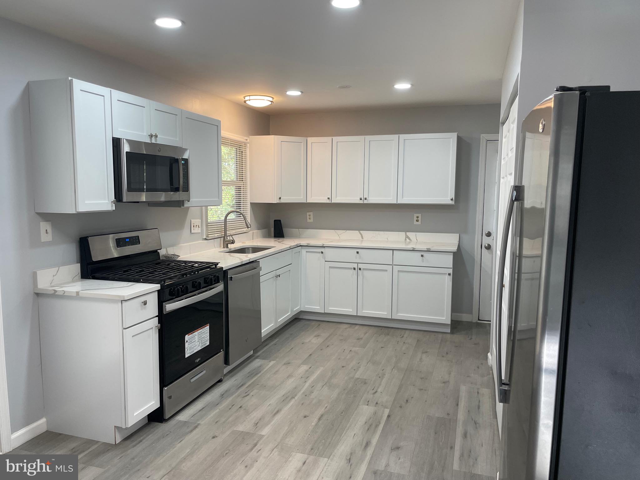 229 Garner Avenue Waldorf, MD 20602 - Photo 3 of 25 a kitchen with a sink stove and refrigerator