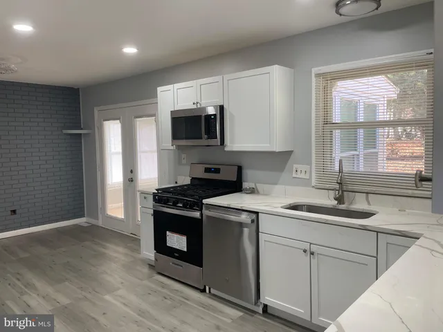 a kitchen with a sink stove and microwave