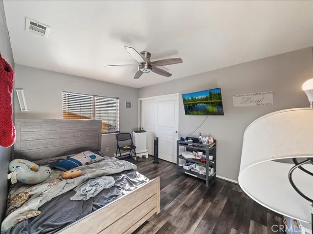 a bedroom with furniture and wooden floor