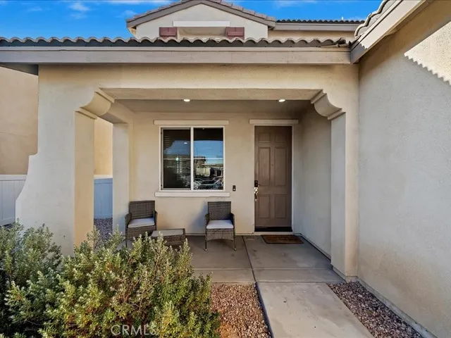 a view of a patio with table and chairs