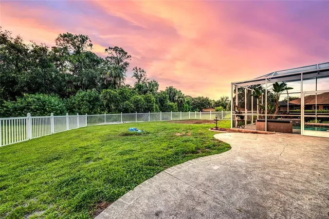 a view of a house with backyard and a garden
