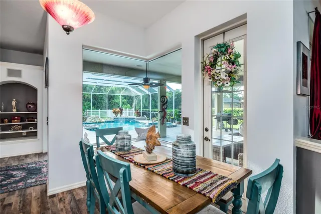 a dining room with furniture a rug and a potted plant