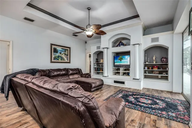 a bedroom with bed ceiling fan and a window