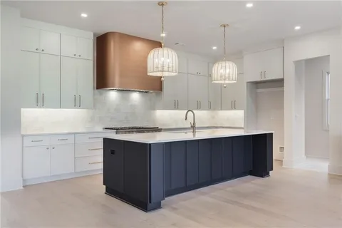 a kitchen with a sink chandelier and a stove