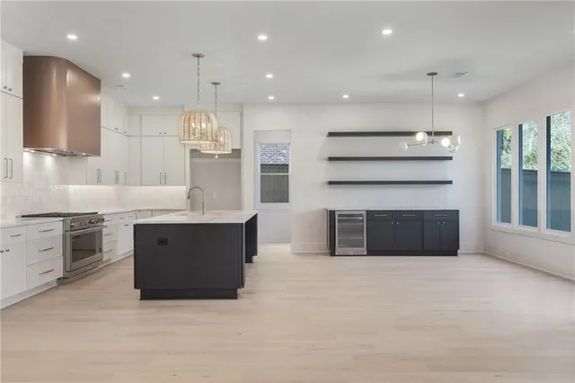 a large kitchen with kitchen island a sink stainless steel appliances and a counter top space