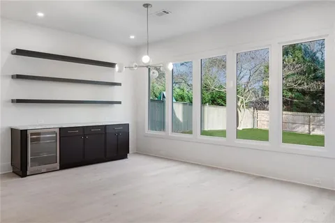 a view of an empty room with a fireplace and a large window